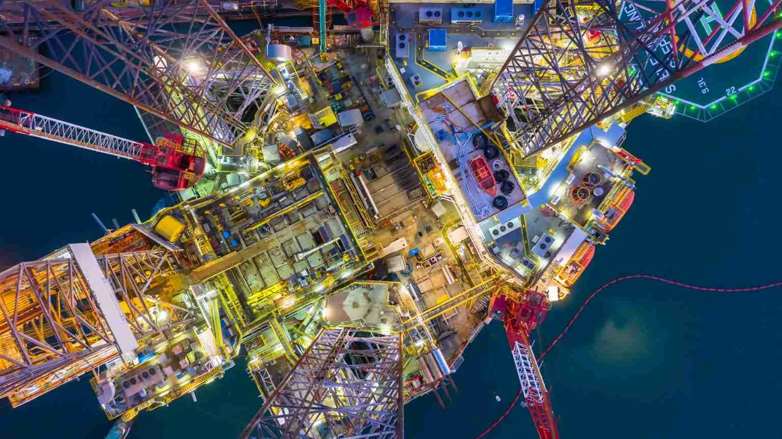 Aerial view offshore jack up rig at night, Offshore oil rig drilling platform.
