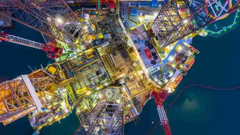 Aerial view offshore jack up rig at night, Offshore oil rig drilling platform.